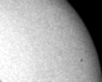 black
      and white photo of a quarter of sun disk with a point is Mercury