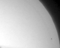 black
      and white photo of a quarter of sun disk with a point is Mercury
