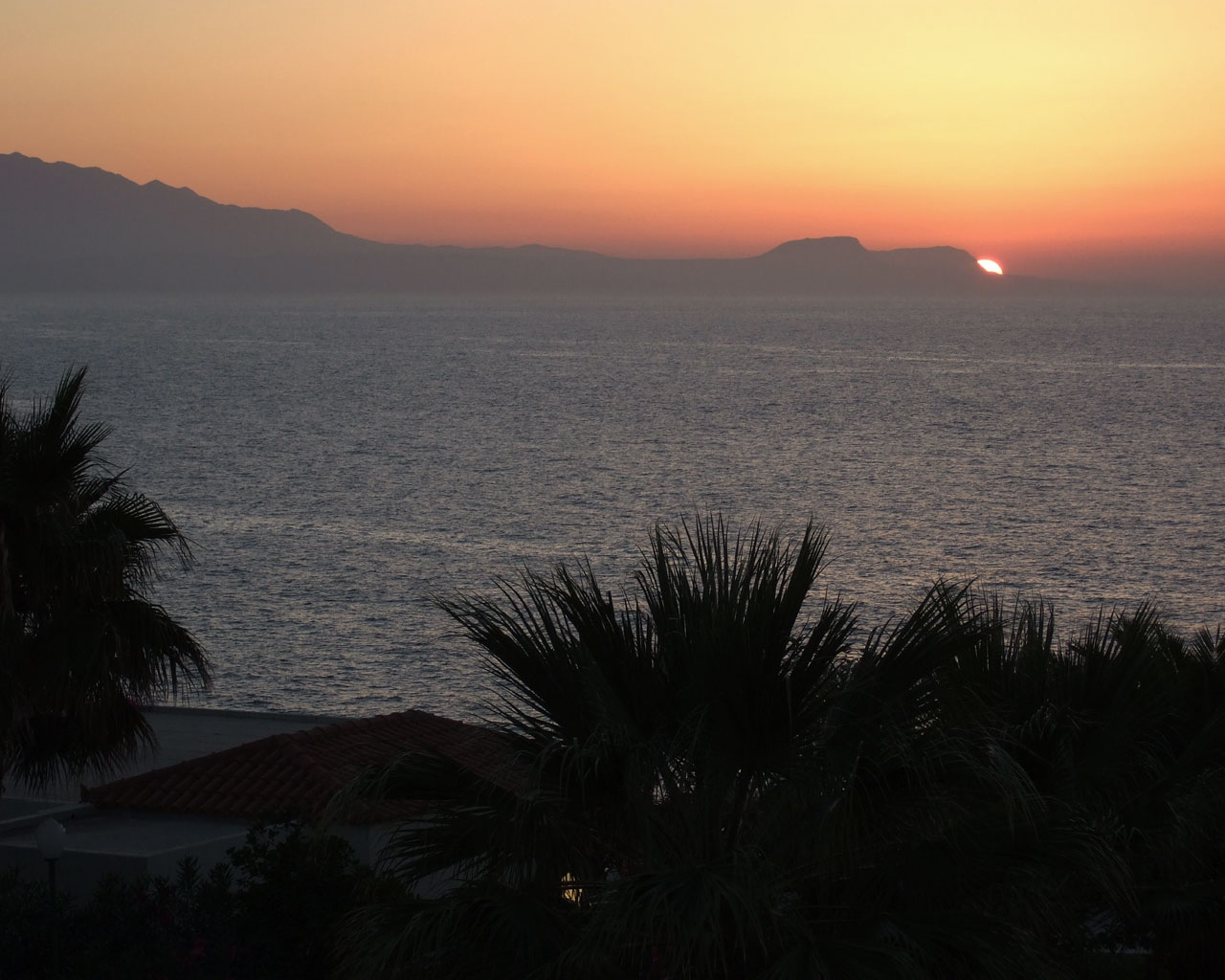 Sun nearly set behind the mountain
      in the sea.